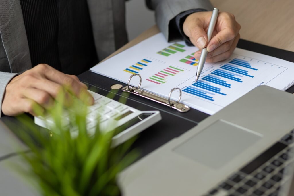 Businessman working about financial with calculator at office to calculate expenses.