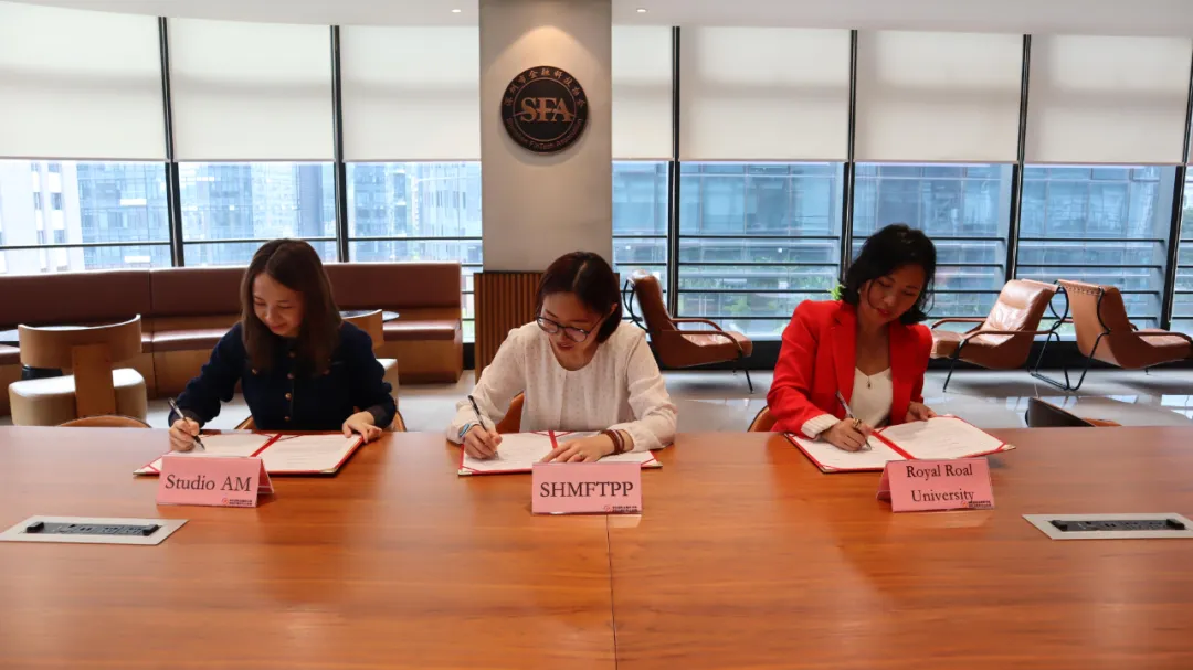 A diverse group of professionals collaborating around a table with laptops and charts.