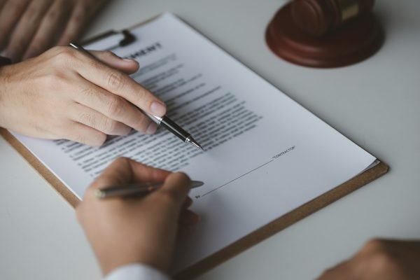 A female financier is reviewing company financial documents.