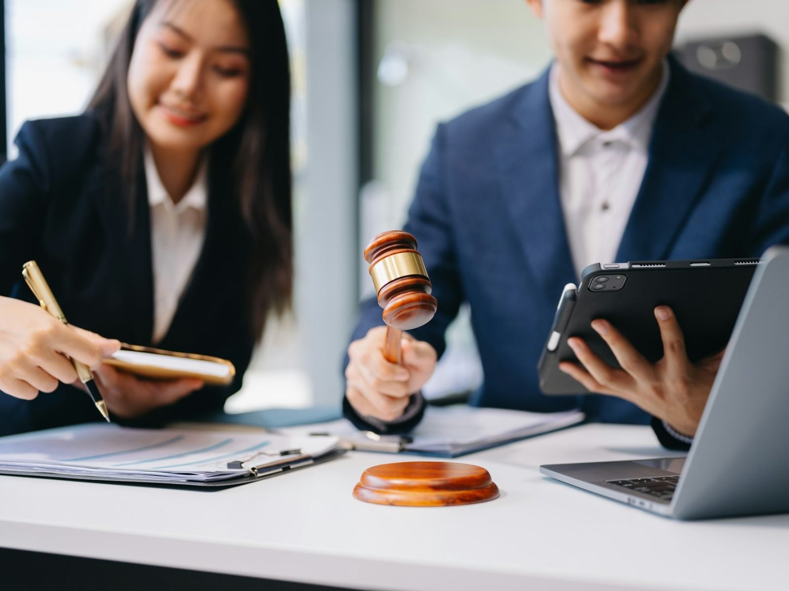 Two lawyers are discussing about contract paper, law matters determination, pointing.law and hammer